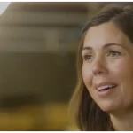 A video thumbnail showing a smiling woman with the woom logo in the corner.