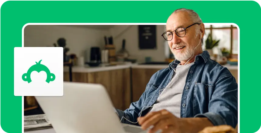 Man wearing headphones and using a laptop, next to an image of SurveyMonkey's logo